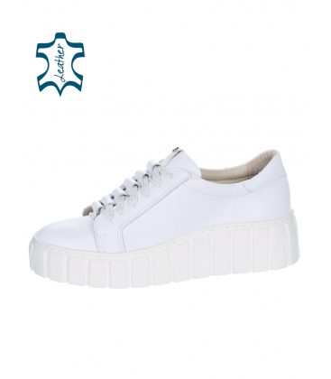 White sneakers with a frill on the tongue