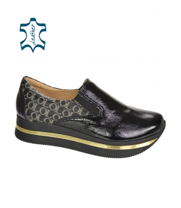 Black glossy slip-on sneakers with a gold OL monogram on the KARLA DTE3314 sole 