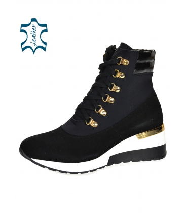 Black ankle boots with gold details and elastic material on a white sole DKO3022