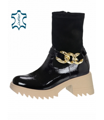 Black shiny ankle boots with decoration on a beige sole DKO2341